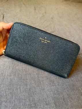 kate spade black glitter zip-around wallet with gold logo
